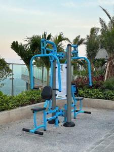 a blue gym with two chairs in front of the ocean at AnVy house Skyforest 2 Ecopark in Xuân Quan