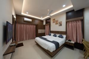 a bedroom with a large bed and a television at Le Sea Sun in Pūrnānkuppam