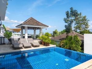 a swimming pool with chairs and a gazebo at Baan Iris 2Br Private Pool & Sunrise Deck in Chaweng