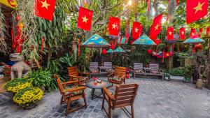 a patio with chinese flags and chairs and a table at Oáza coffee & bar in Hanoi