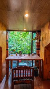 a wooden table in a room with a large window at Oáza coffee & bar in Hanoi