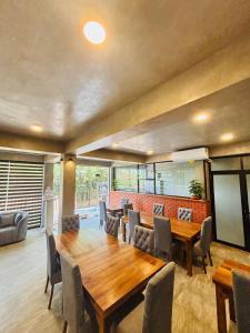 a dining room with a wooden table and chairs at Ceylan Dream Hiriketiya in Nilwella