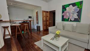 a living room with a couch and a table at The Joy Beach Villas in Hinkong