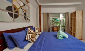a bedroom with a bed with blue sheets and pillows at The Joy Beach Villas in Hinkong +181 photos