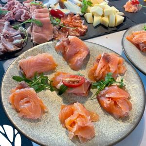 a plate of food with salmon and meat and cheese at De Kempische Hoef in Westerlo