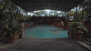 a room with a table and chairs and plants at bethi farms in Malkāpur