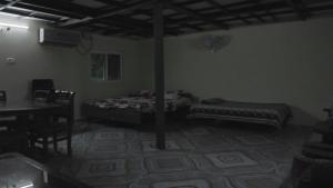 a bedroom with a bed and a table in a room at bethi farms in Malkāpur