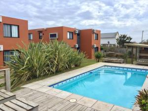a swimming pool in the yard of a house at Las Pakas in La Paloma