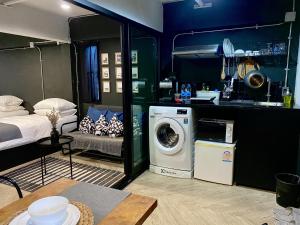 a kitchen with a washing machine in a room at Bedsment in Chiang Rai
