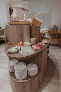 a kitchen with a counter with plates and food at Gästehaus Achental in Berchtesgaden