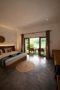 a bedroom with a bed and a large window at Amanda Riverside in Nongkhiaw