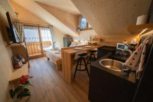 a kitchen and living room in a tiny house at Appartamenti Casa Sabry in San Niccolò Comèlico