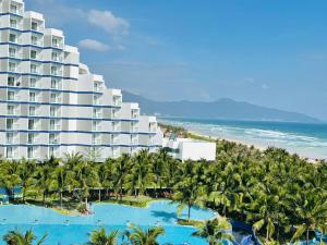 an aerial view of a resort with palm trees and the ocean at Arena Oceanview Cam Ranh - Infinity swimming pool in Cam Ranh International Airport