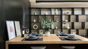 a dining room table with plates and wine glasses at Bedsment in Chiang Rai