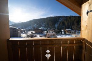 a balcony with a view of a snow covered mountain at Appartamenti Casa Sabry in San Niccolò Comèlico