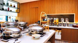 a kitchen with several pots and pans on a counter at OZO George Town Penang in George Town