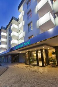 a hotel building with a sign that reads new mutual hotel at Hotel Lux Mundi in Fátima