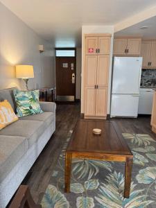 a living room with a couch and a coffee table at The Happy Hideaway - Maui Calm by the Ocean in Kihei +3 photos