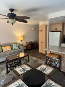 a living room with a couch and a table at The Happy Hideaway - Maui Calm by the Ocean in Kihei