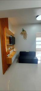 a bedroom with a blue bed and a desk at Ubec Vacation Home - Royal Oceancrest Mactan Cebu Condominium in Cebu City