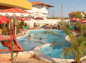 a swimming pool with two people in it at Hotel Varvara in Varvara
