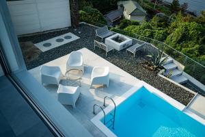 a view of a patio with chairs and a pool at Amatera in Kami Amakusa
