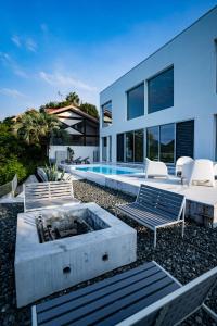 a backyard with a fire pit and a house at Amatera in Kami Amakusa