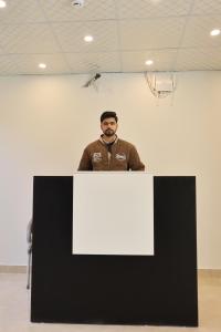 a man standing behind a black and white table at Bahria Premium Hotel in Rawalpindi
