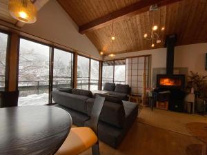 a living room with a couch and a table at kakayama hutte in Muraoka