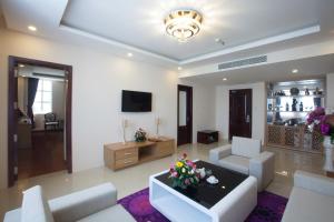 a living room with a couch and chairs and a tv at Khanh Linh Hotel in Pleiku