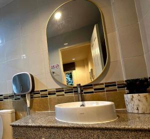 a sink in a bathroom with a mirror at The Atlas hostel Muang Thong Thani in Thung Si Kan