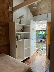 a bedroom with a bed and a book shelf at Balay Yuhom in General Luna