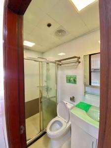 a bathroom with a toilet and a shower and a sink at LG-15B City Center Staycation at Megatower 1 in Baguio