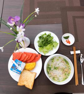 a table with three plates of food and bowls of food at Red River View Hotel in Lao Cai +100 photos