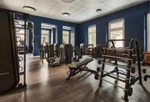 a gym with several tread machines and blue walls at Laudinella Apartments in St. Moritz