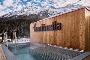 a sign on the side of a building with a swimming pool at Laudinella Apartments in St. Moritz +31 photos