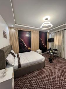 a bedroom with a bed and a desk and a couch at FASARESIDENCE Dakar Point E CHAMBRE NOFLAYE in Dakar
