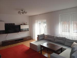 a living room with a couch and a table at Dom na Konwaliowej in Narew