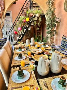 a long table with plates of food on it at KOUTOBIA ROYAL in Marrakesh