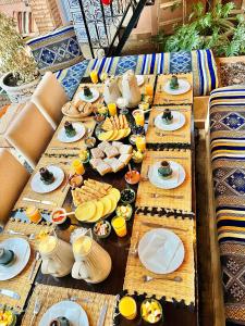 a long wooden table with plates of food on it at KOUTOBIA ROYAL in Marrakesh +142 photos