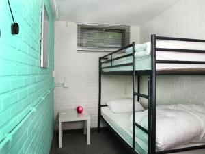a room with two bunk beds and a table at Quaint Villa in Doornspijk with Swimming Pool in Doornspijk +76 photos