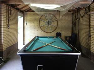 a pool table sitting in a room with a wall at Quaint Villa in Doornspijk with Swimming Pool in Doornspijk