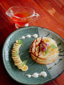 a plate of food with a dessert on a table at Eco Vibe Resort in Rattota +58 photos