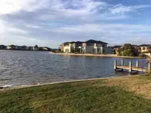 a large body of water with houses and a dock at Point Cook Homestay House in Point Cook