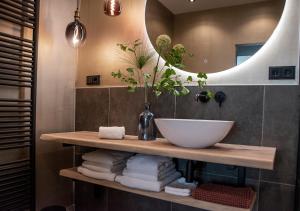 a bathroom with a sink and a mirror at B and B Suite No.3 in Gorinchem