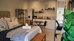 a living room with a bed and a small kitchen at Seaside at The Dunes in Plettenberg Bay