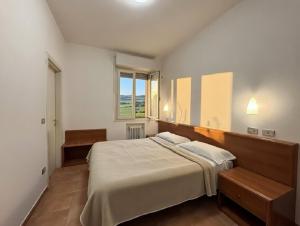 a bedroom with a large bed and a window at Hotel Serena in Riolo Terme +5 photos