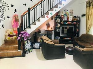 a living room filled with furniture and a staircase at Shanu home stay in Beliatta