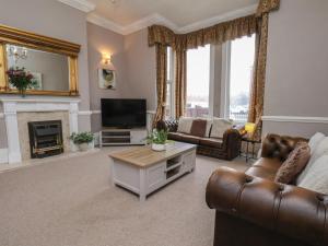 a living room with a couch and a television at Bridlington Bay House in Bridlington