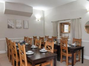 a dining room with a wooden table and chairs at Bridlington Bay House in Bridlington